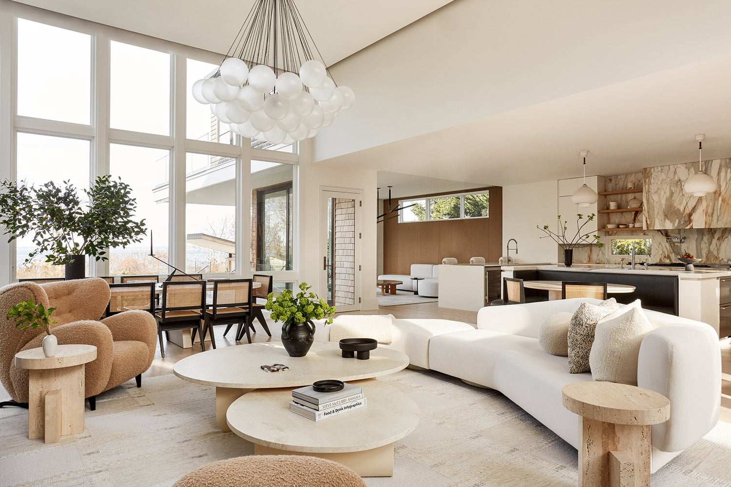 Organic modern living room with sculptural curved sofa in neutral tones