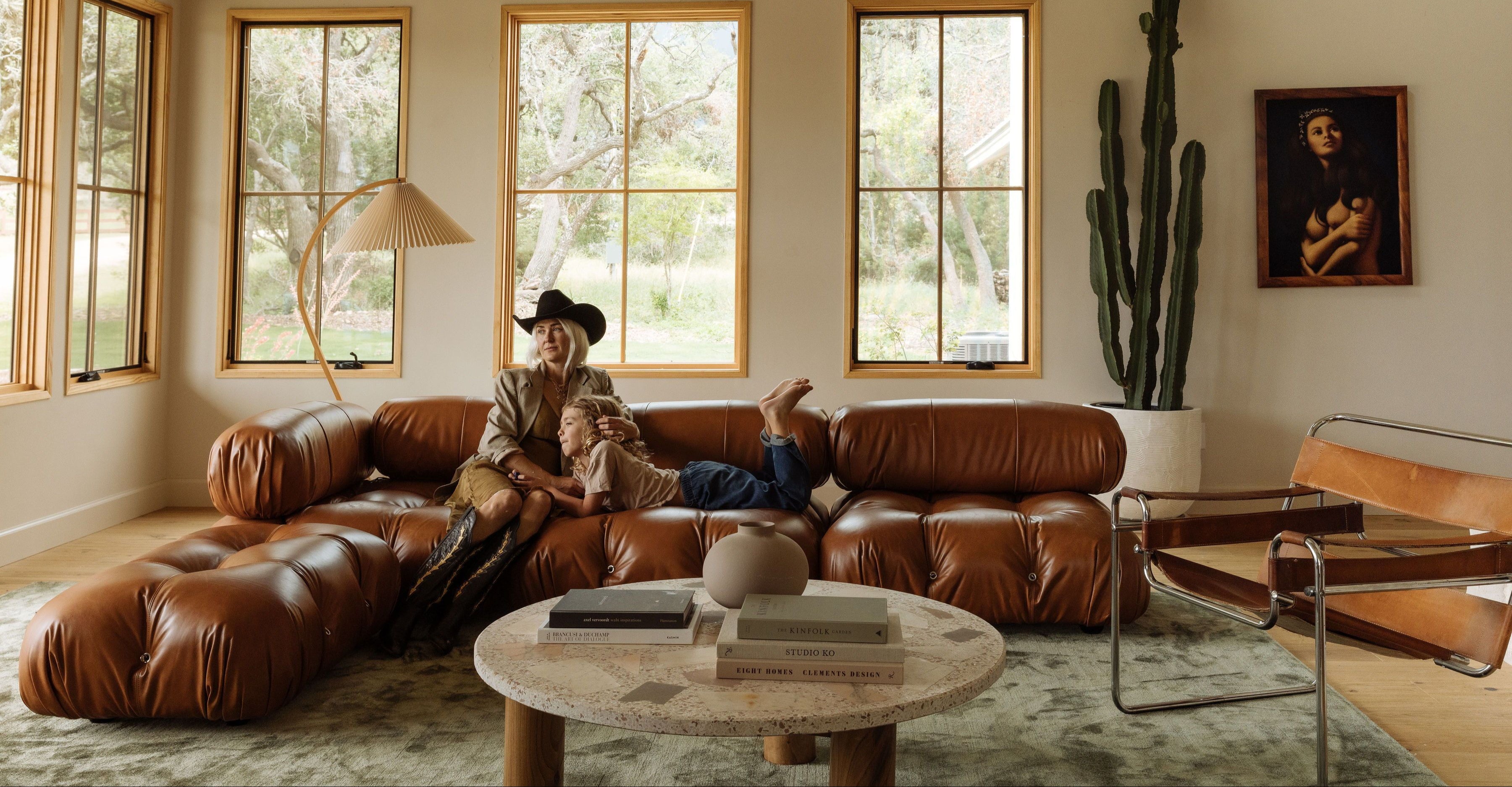 Living room with a brown sectional sofa, coffee table, and decorative items.