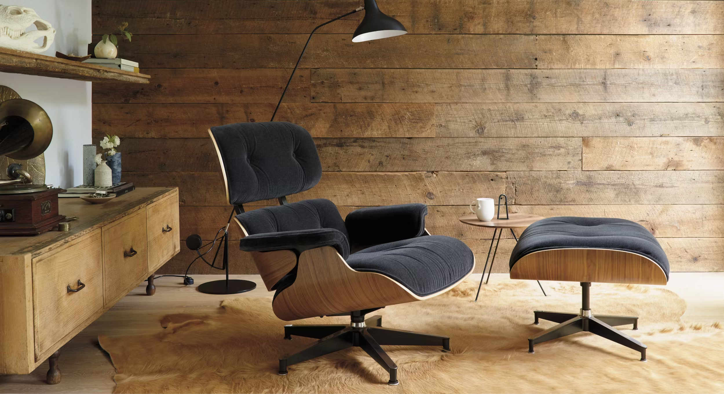 Modern lounge chair and ottoman in a room with wooden walls and shelves.