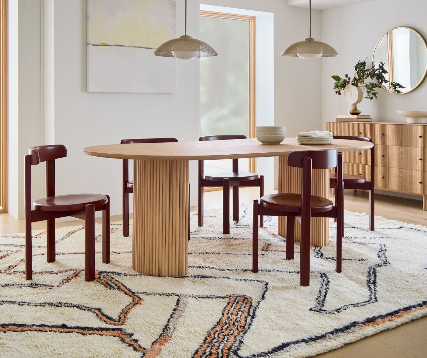Dining room with oak wooden table and chairs on a patterned rug