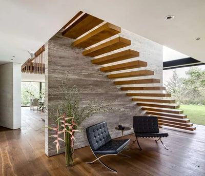 Modern interior with wooden staircase, black chairs, and decorative plants.