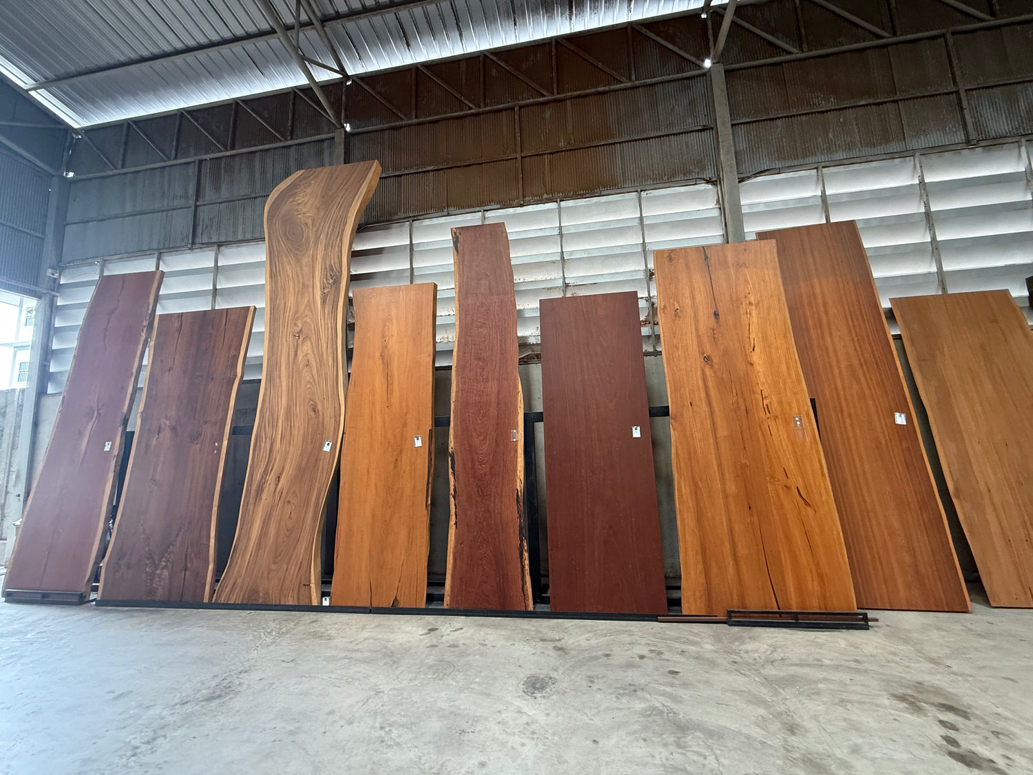 Row of wooden slabs in a warehouse setting
