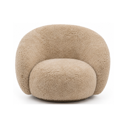 A modern, low-profile barrel chair upholstered in a genuine sheepskin or sherpa fabric in a warm beige/tan color, shown against a plain white background.