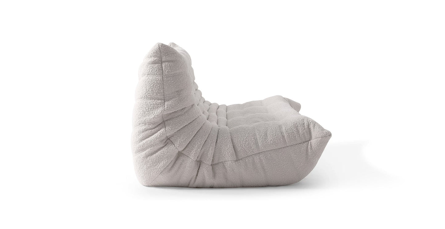 boucle off white low profile sofa in a white background