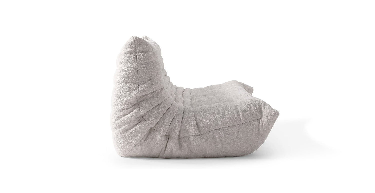 boucle off white low profile sofa in a white background