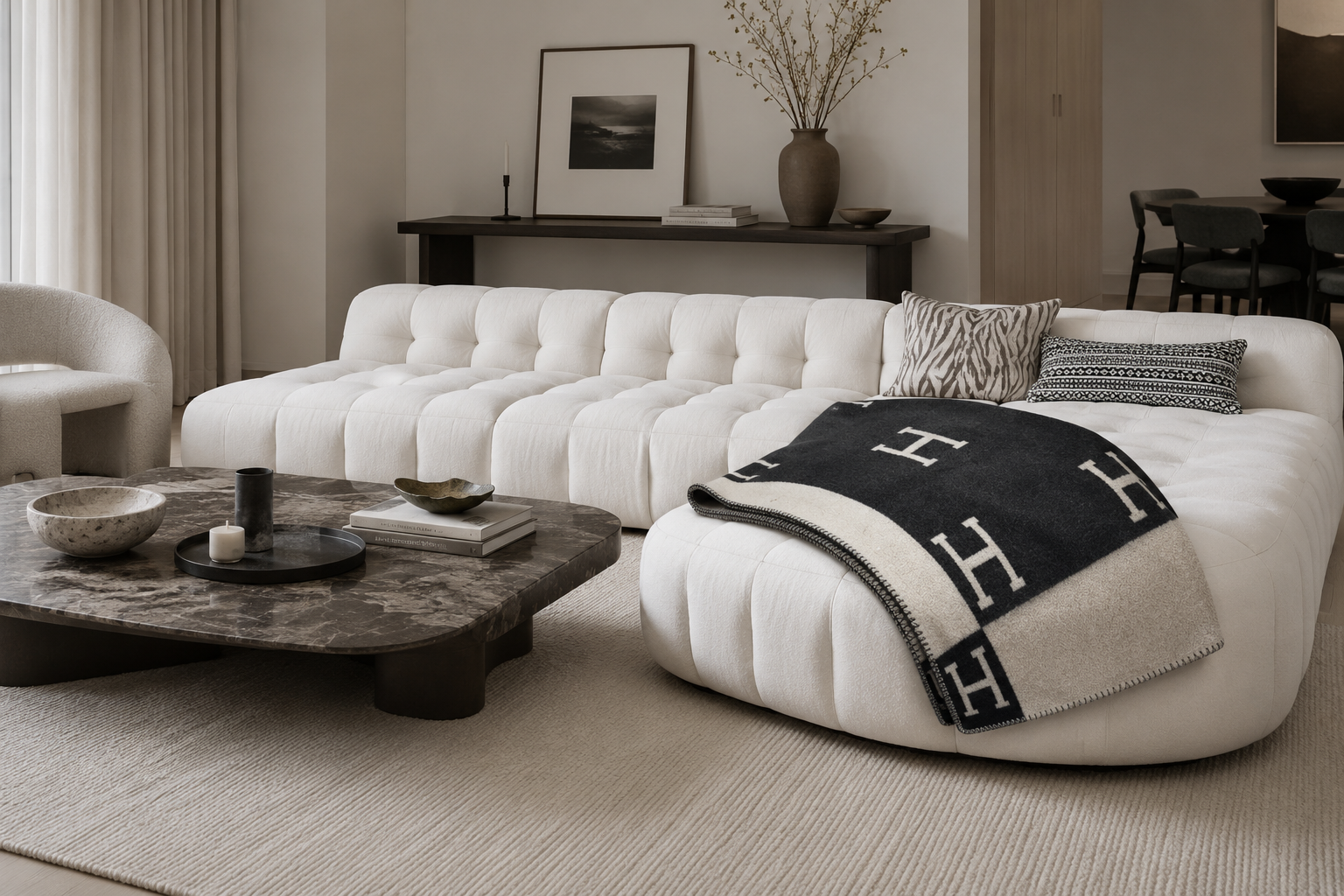 black cashmere throw blanket, on a white curved sofa