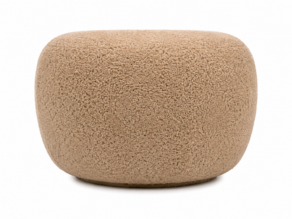 A modern, organic-shaped pouf or ottoman with a genuine sheepskin fabric in a warm honey color, shown on a plain white background.