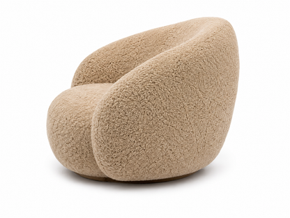 A modern, low-profile barrel chair upholstered in a genuine sheepskin or sherpa fabric in a warm beige/tan color, shown against a plain white background.