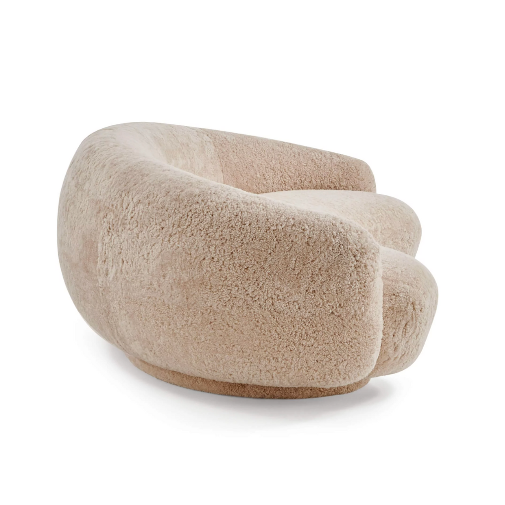Beige moon shaped sofa ingenuine sheepskin on a white background