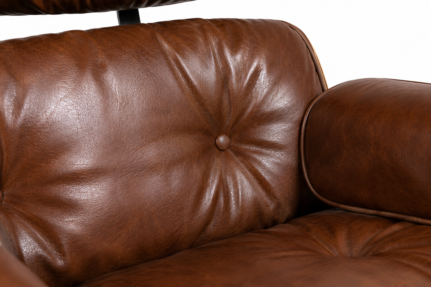 Close-up of a brown leather armchair with a tufted button on the backrest and a matching leather armrest, photographed against a white background.