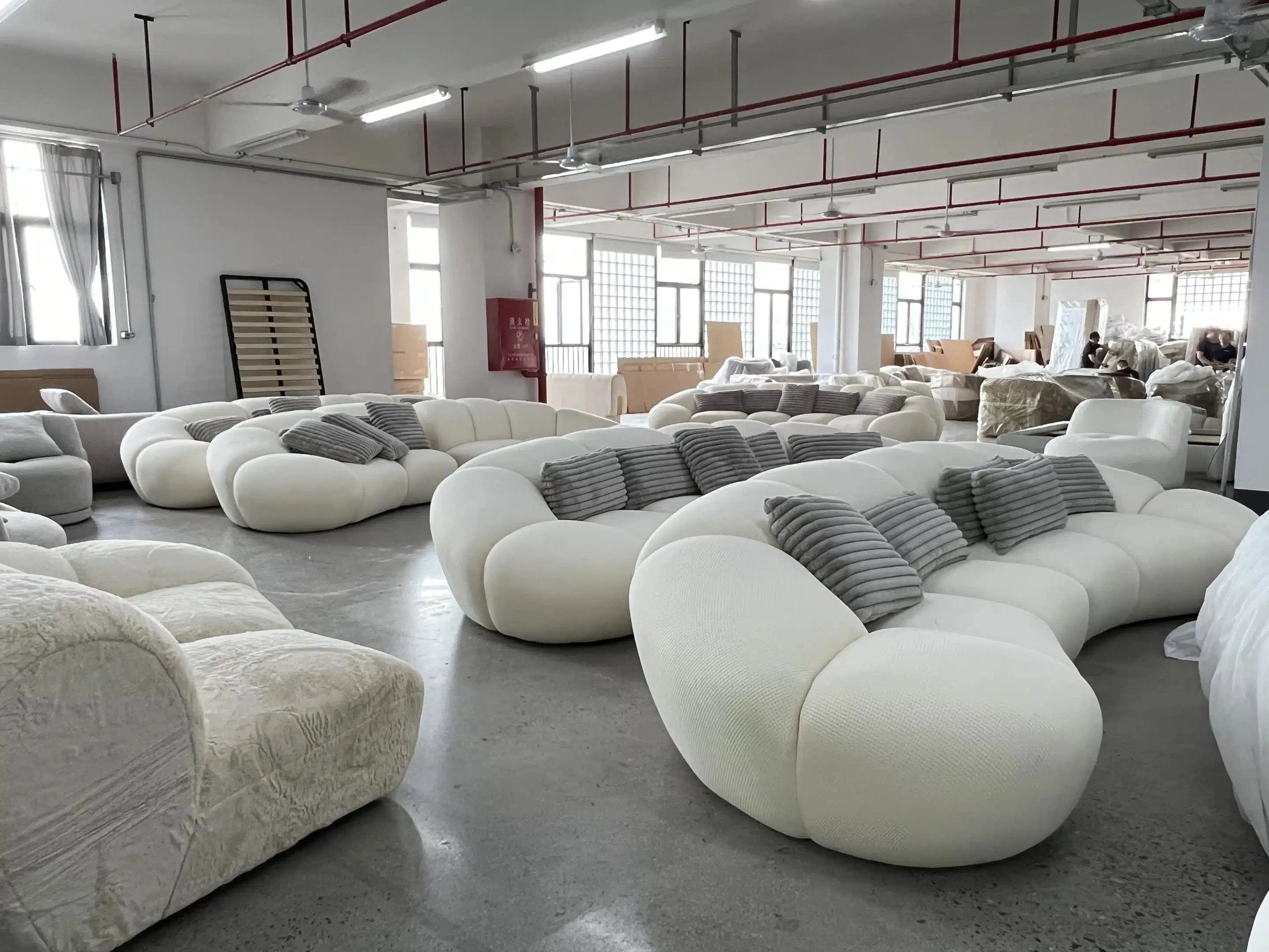 off white curved sofa edition manufactured in a factory, production photo